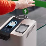 Une personne présente sa main au-dessus d'un scanner pour effectuer un paiement.