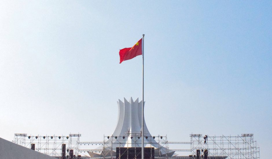 Le drapeau chinois en train de flotter devant un ciel bleu.