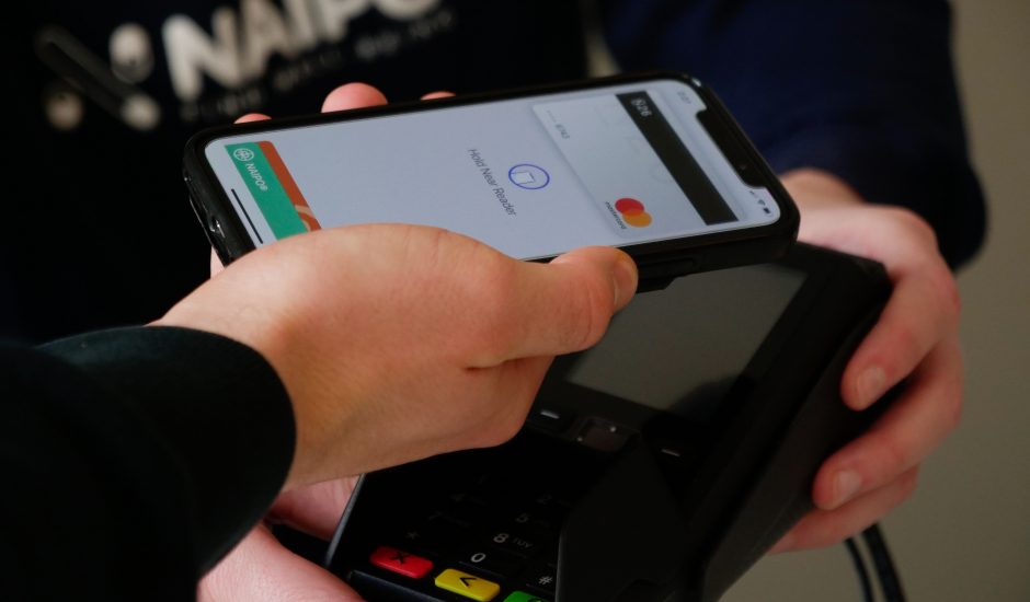 Une personne en train d'utiliser Apple Pay avec son iPhone.