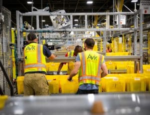 Deux employés travaillent dans un entrepôts Amazon.