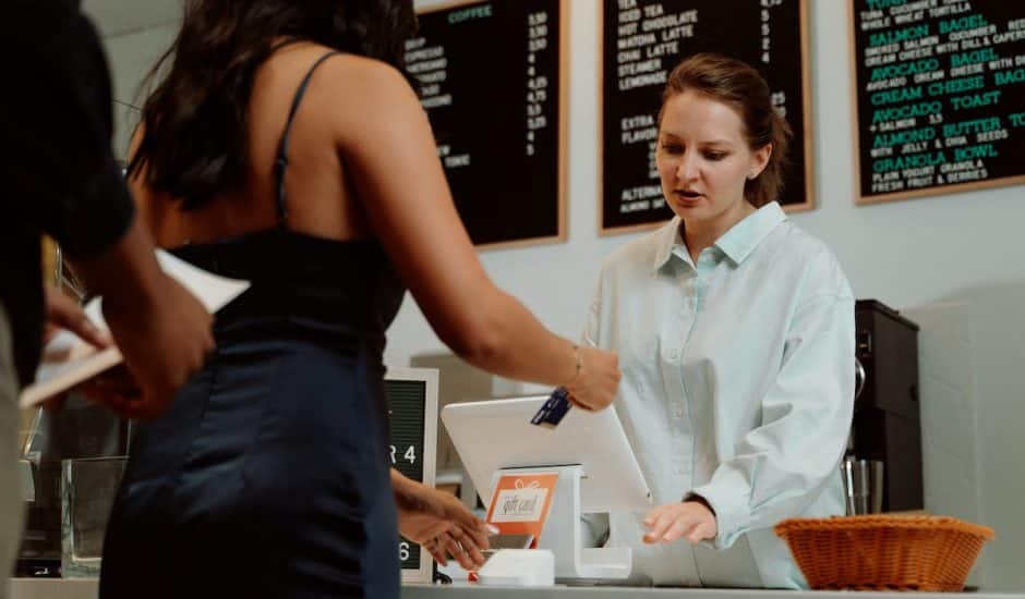 une femme en train de payer dans un café