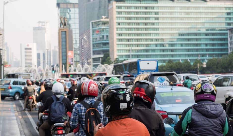 Photographie d'une route de Jakarta avec des dizaines de scooters et des voitures.